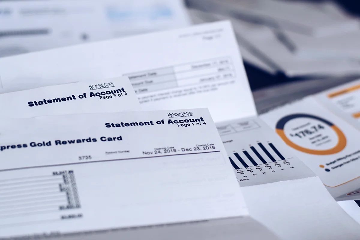 Multiple financial documents spread out on a desk.