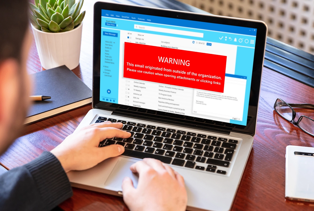 Email Attachments Warning Message - Computer Headquarters Laptop displaying red warning banner about external email security risk, advising caution with attachments and links.
