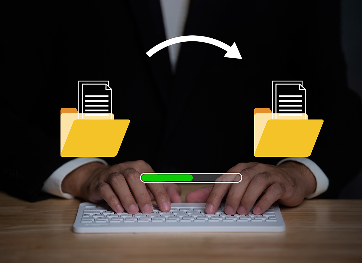 Hands typing on a keyboard with folder icons and a progress bar overlay, representing file transfer, data migration, or document copying.