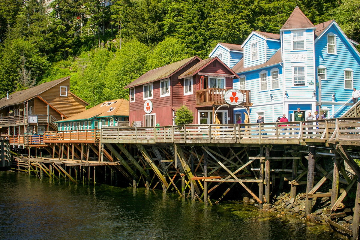Colorful historic buildings on Creek Street in Ketchikan, Alaska, built on wooden stilts over the water
