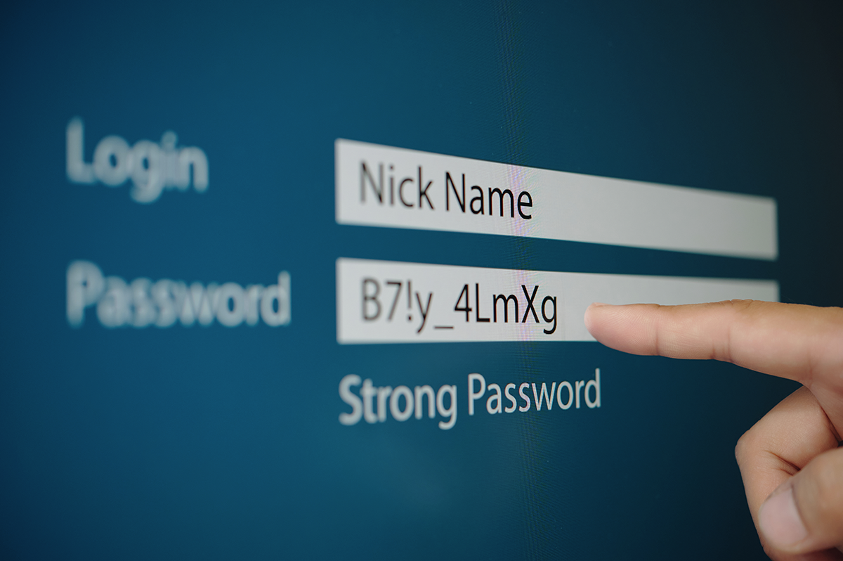 Login screen showing a nickname field and an example strong password, with a finger pointing at the password entry field.