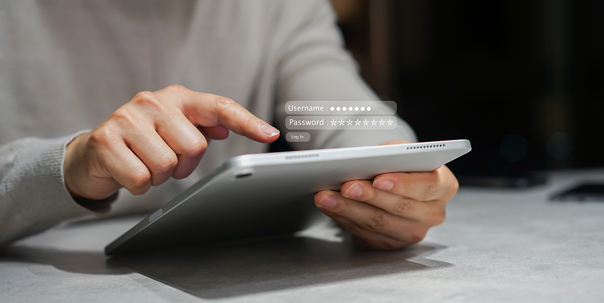 Person using a tablet with a floating login interface showing username and password fields.